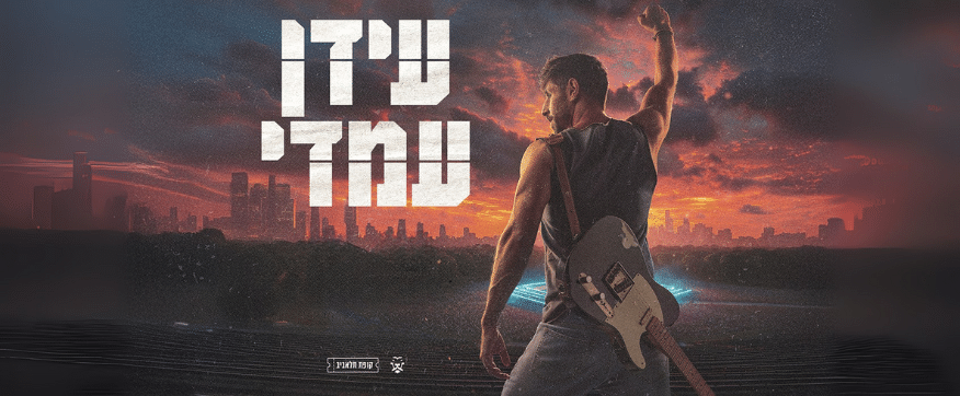 תמונה של עידן עמדי מהגב על רקע שמיים אדומים, על גבו תלויה גיטרה